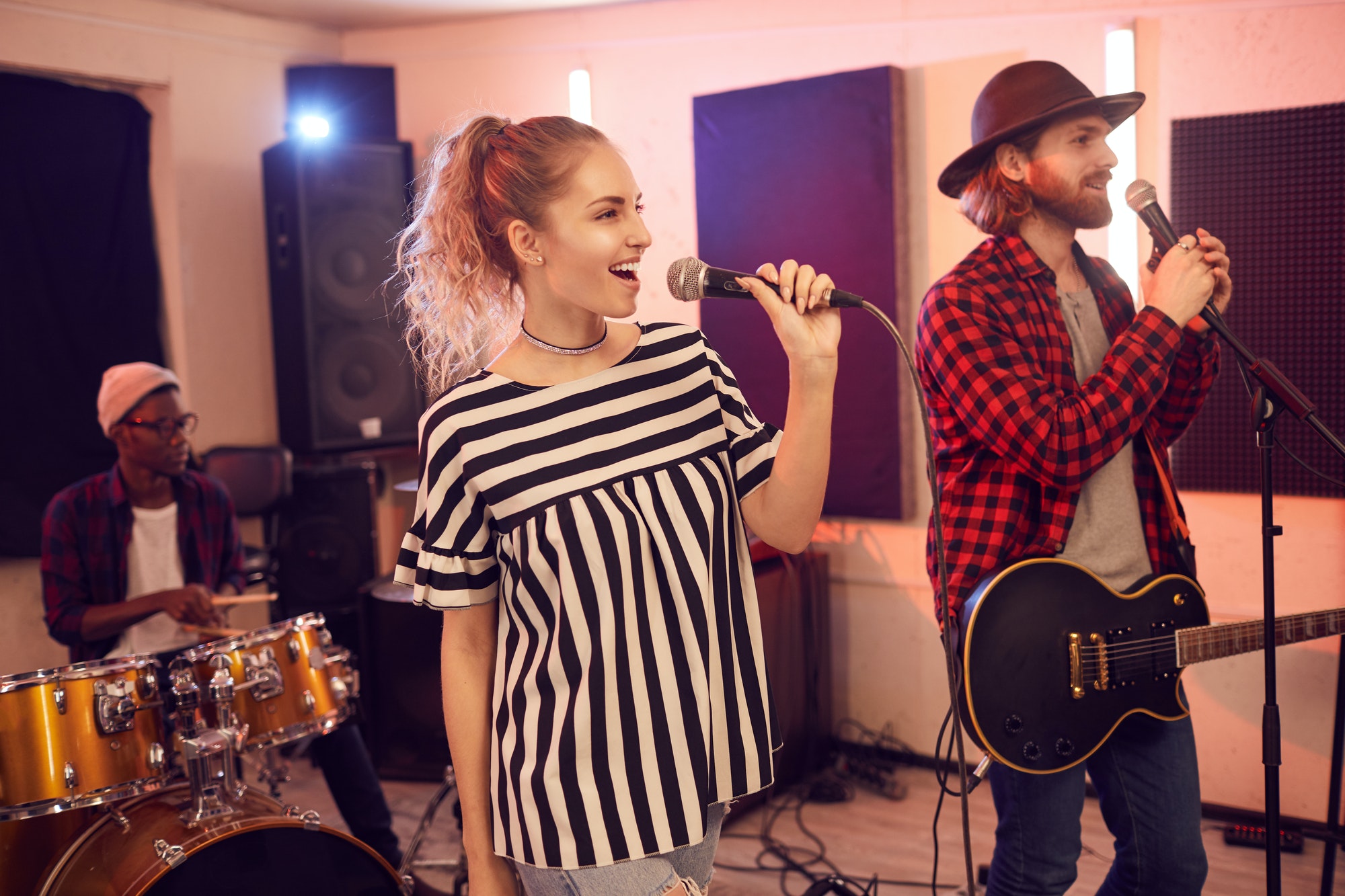 Beautiful Young Woman Singing with Band